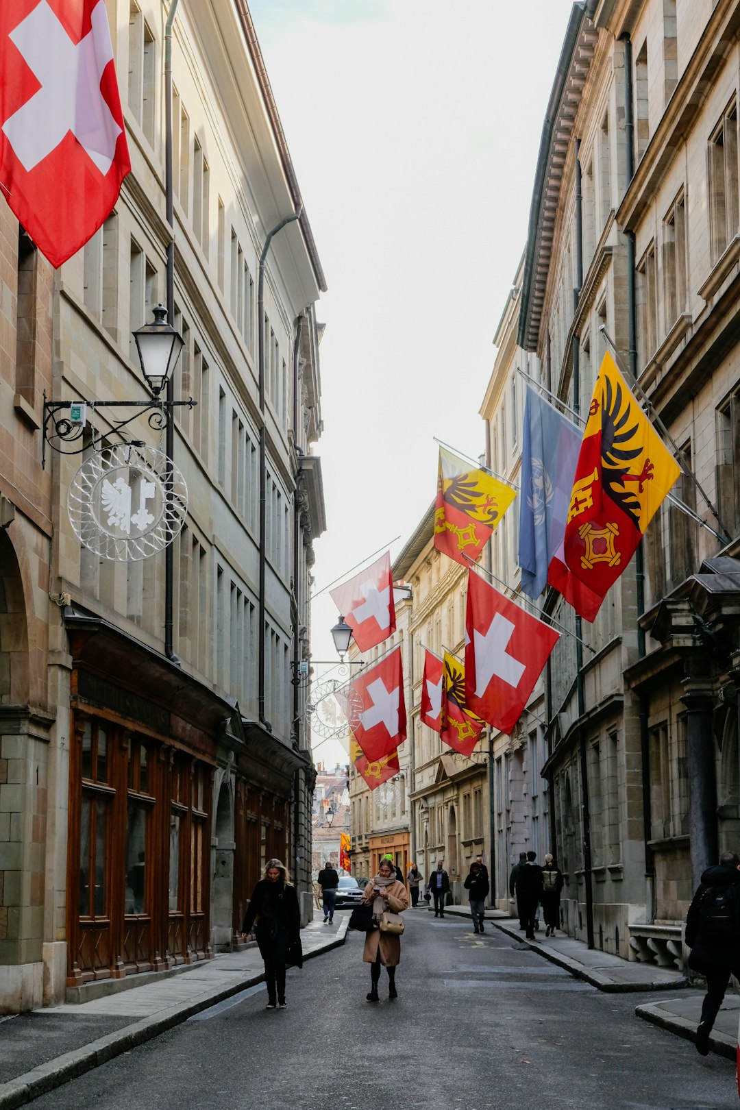 people-walking-down-a-street-lined-with-flags-2ojmk5n7yp0